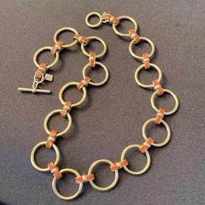 Banana Republic gold tone circle link necklace with dark coral color grommets